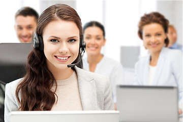 Image showing helpline operator with headphones in call centre