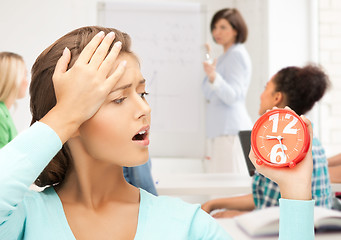 Image showing attractive student looking at clock