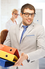 Image showing businessman with folders in office