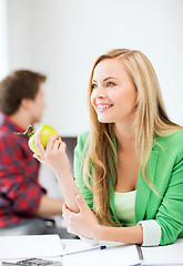 Image showing student girl with green apple in college