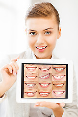 Image showing female doctor with tablet pc and smiles