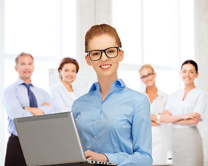 Image showing businesswoman with laptop computer at work