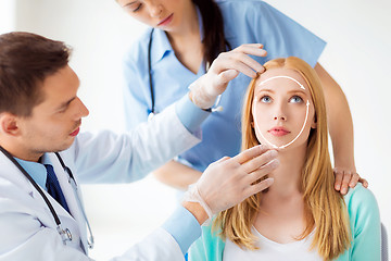 Image showing male plastic surgeon with patient