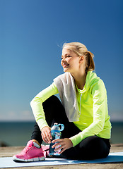 Image showing woman resting after doing sports outdoors