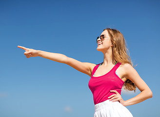 Image showing girl showing direction on the beach