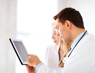 Image showing two doctors looking at x-ray on tablet pc