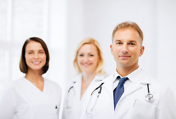 Image showing doctor with stethoscope and colleagues