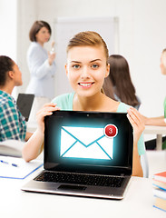 Image showing girl holding laptop with email sign at school