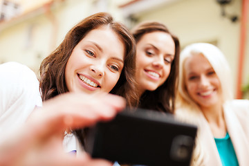 Image showing beautiful girls taking picture in cafe in city