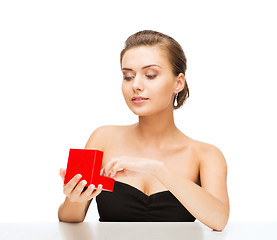 Image showing woman with diamond earrings and gift box