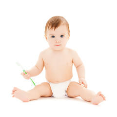 Image showing curious baby brushing teeth