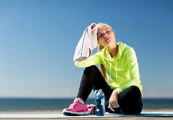 Image showing woman resting after doing sports outdoors