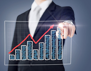 Image showing businessman hand with chart on virtual screen