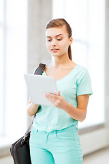 Image showing smiling student with tablet pc in college