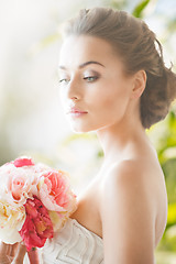 Image showing young woman with bouquet of flowers