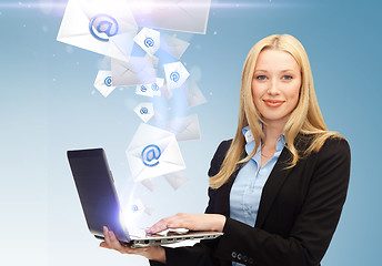 Image showing businesswoman holding laptop with email sign