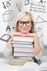 Image showing student with stack of books and doodles