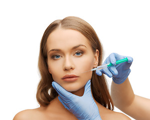 Image showing woman face and beautician hands with syringe