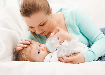 Image showing mother and adorable baby with feeding-bottle