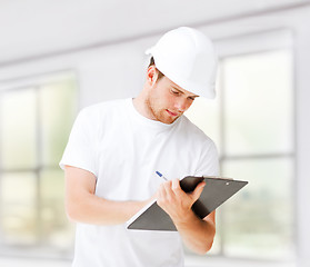 Image showing male architect looking at blueprint