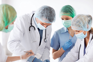 Image showing young group of doctors doing operation