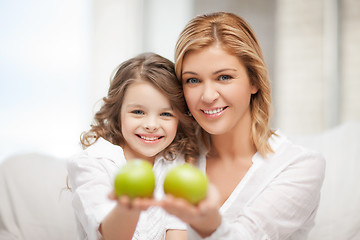 Image showing mother and daughter holding green apples