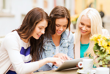 Image showing beautiful girls looking at tablet pc in cafe