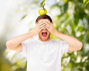 Image showing man with green apple on his head