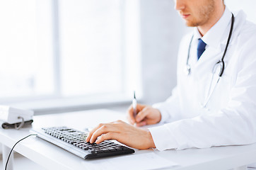 Image showing male doctor typing  on the keyboard