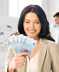 Image showing happy businesswoman with cash money in office