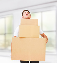 Image showing young man carrying carton boxes