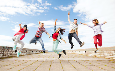 Image showing group of teenagers jumping