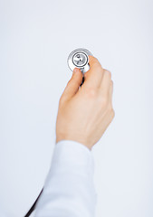 Image showing doctor hand with stethoscope listening somebody