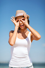 Image showing girl making funny faces on the beach