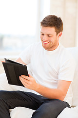 Image showing man working with tablet pc at home