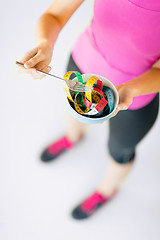 Image showing woman hands holding bowl with measuring tape