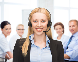 Image showing helpline operator with headphones in call centre