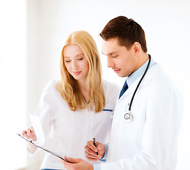 Image showing two doctors writing prescription