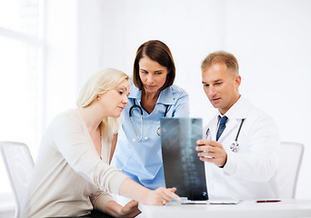 Image showing doctors with patient looking at x-ray