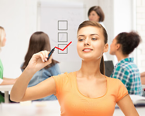 Image showing student drawing checkmark on virtual screen