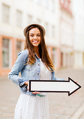 Image showing girl showing direction with arrow in the city