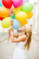 Image showing woman with colorful balloons