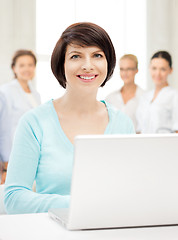 Image showing businesswoman with laptop computer at work