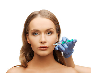 Image showing woman face and beautician hands with syringe