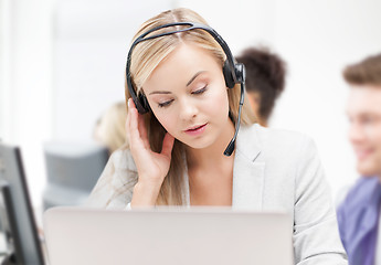 Image showing helpline operator with headphones in call centre