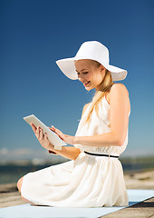 Image showing beautiful woman in a dress with tablet pc