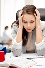 Image showing stressed businesswoman in office