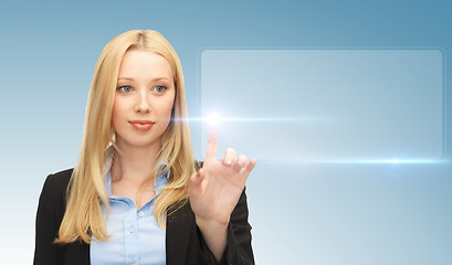 Image showing businesswoman touching virtual screen