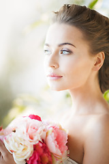 Image showing young woman with bouquet of flowers