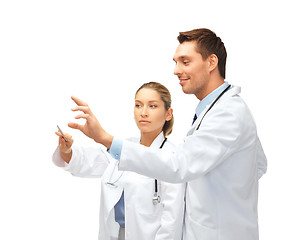 Image showing young doctors working with something imaginary